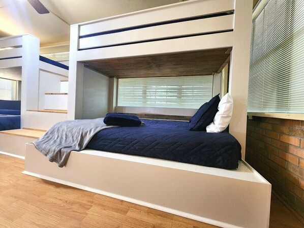 A bunk bed with a built-in desk and window, featuring a view of the outdoors. - Close to Foley Sports Complex,OWA- Sleeps 12- House w/2 Dens & 2 Dining Areas- (Foley)