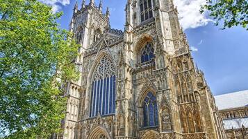 A historic cathedral with intricate Gothic architecture, featuring tall spires and large stained glass windows.