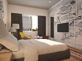 Una habitación de hotel moderna con una cama grande, un escritorio, una silla, un televisor y un ventanal con cortinas.