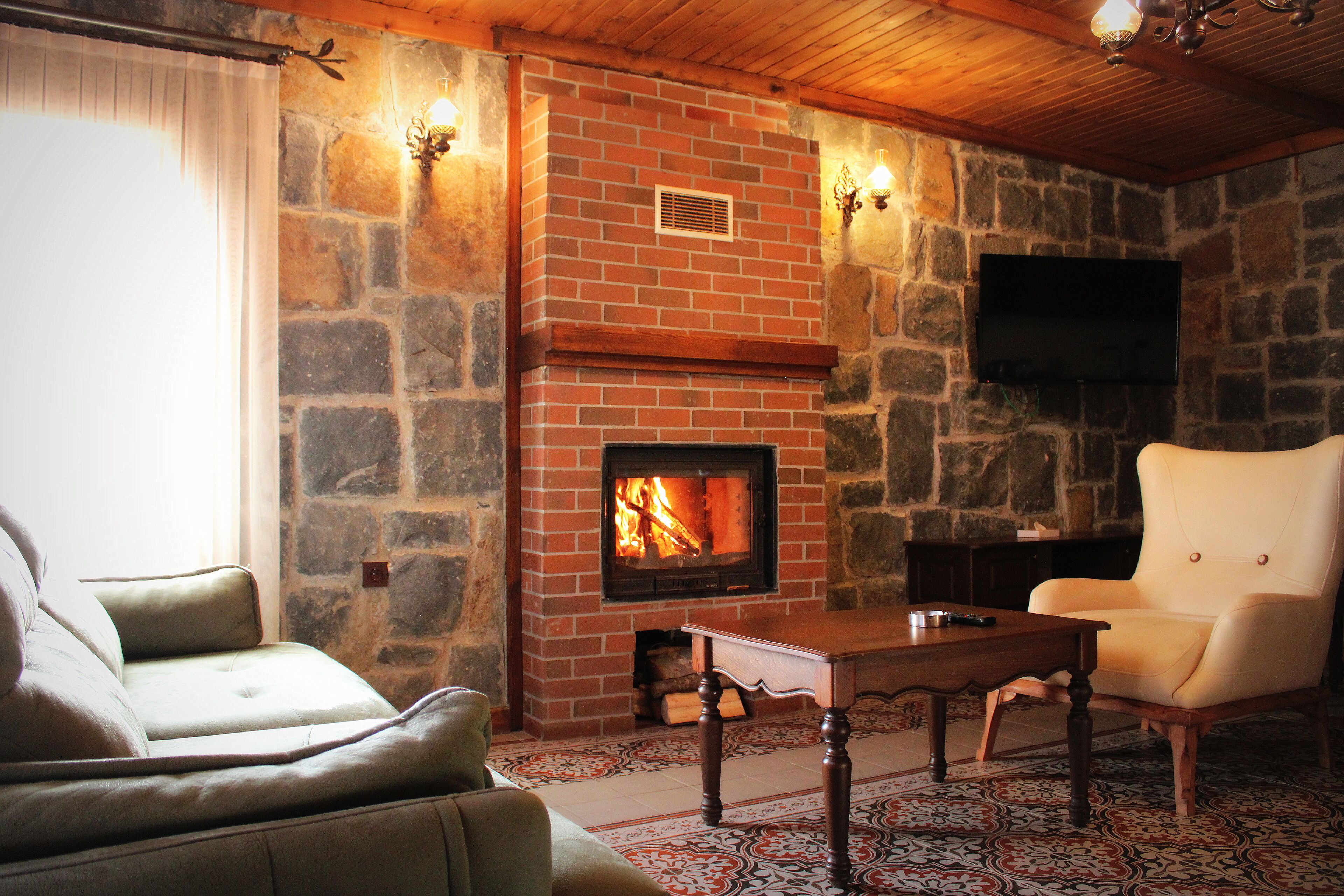 deluxe suite | living area | 50-inch lcd tv with satellite channels, tv, heated floors