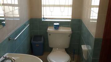 Economy Room | Bathroom | Shower, towels, soap, toilet paper