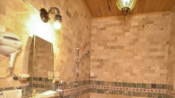 A bathroom with a sink, mirror, and toilet.