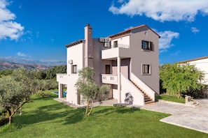 Relax in a spacious outdoor area with a lawn and pool, or enjoy the views from the second-story balcony with a seating area.