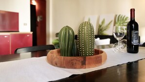 A wooden table with a cactus and a wine bottle. - santamarta35: characteristic apartment in a great location (Pisa)
