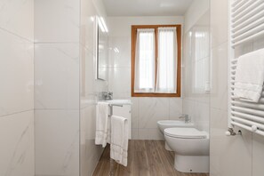 Shower, hair dryer, towels, toilet paper