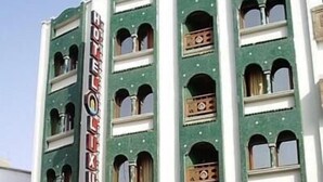 Een meerhoog gebouw met een bord waarop staat: 'HOTEL VAN DE WEEK'.