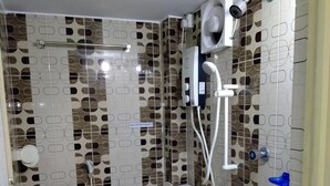 A bathroom with a toilet, bidet, and sink. - Hotel Charu (Barisal)