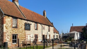 A stone building with a sign reading "White Horse Inn."