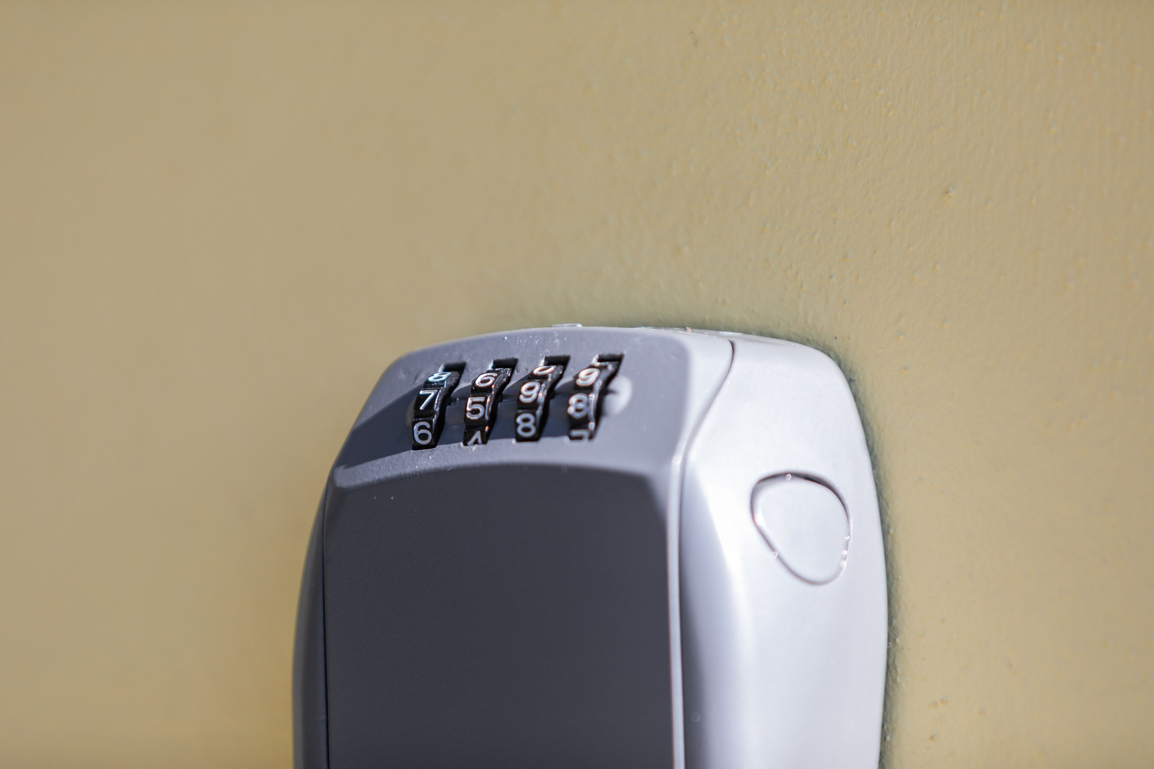 A keypad device, likely a security or access control system, mounted on a wall.