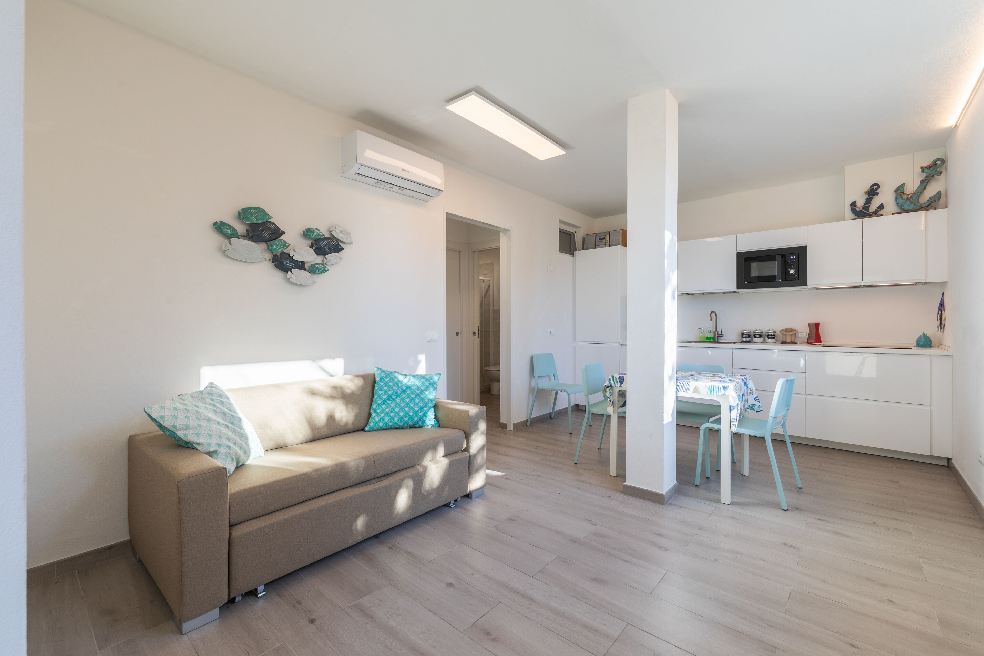 A modern apartment with a living room, kitchen, and dining area.