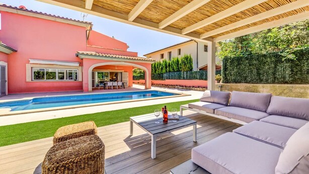 A covered outdoor area with a pool, a sofa, and a wicker ottoman. - Maria Bonaire for eigth people with pool (Alcúdia)
