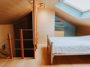 A bedroom with a sloped ceiling, a bed, a wooden ladder, and a skylight. - The Horseshoe with parking by Interhome (Bredene)