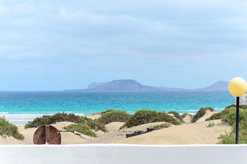 Famara Beach House on the Shore with Shared Pool, Ocean/Mountain Views & Wi-Fi