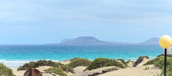 Famara Beach House on the Shore with Shared Pool, Ocean/Mountain Views & Wi-Fi