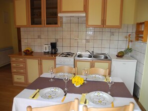 Enjoy cooking and dining in this fully equipped kitchen with a gas stove, sink, and refrigerator.