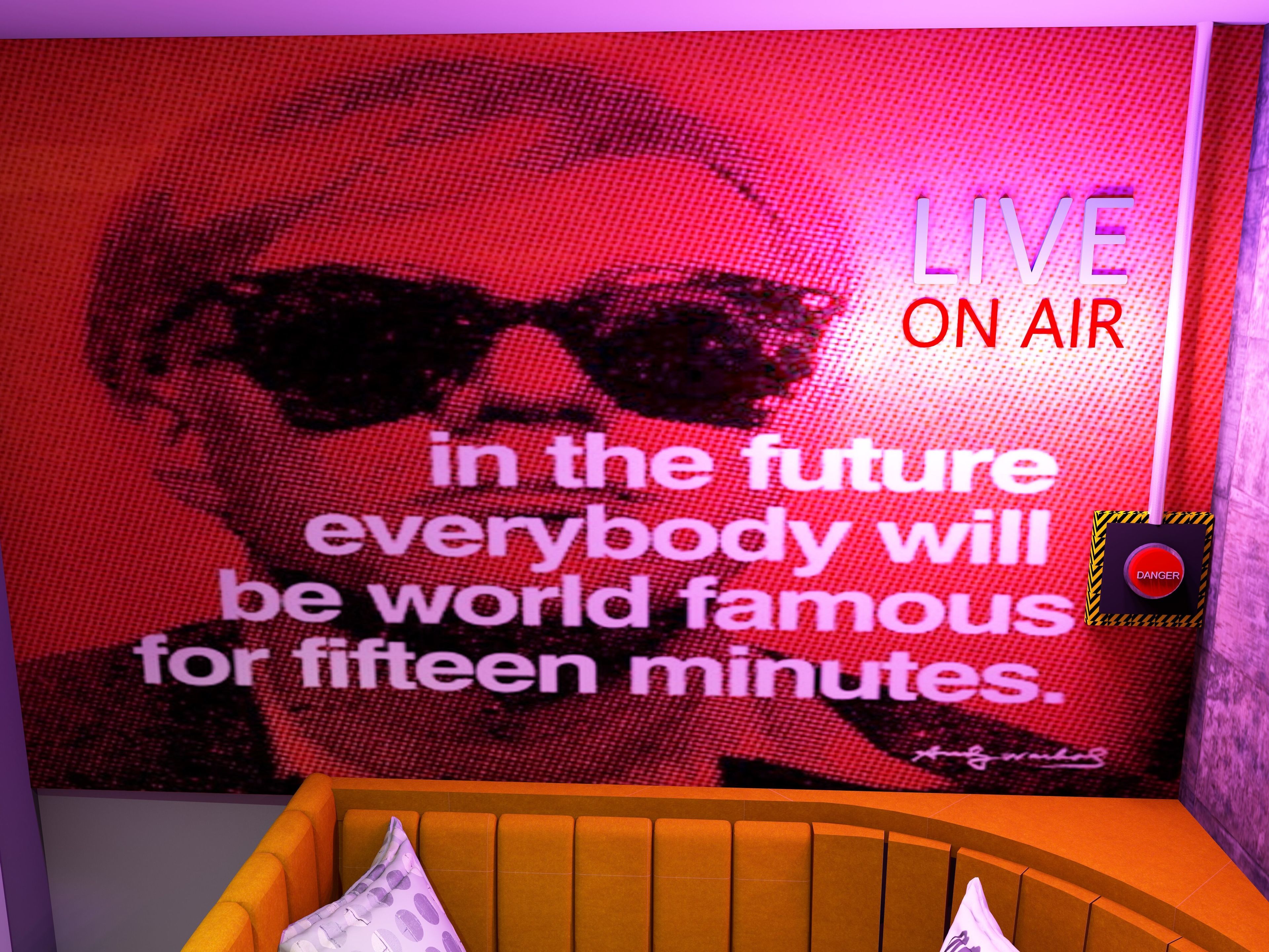 A room with a large LED screen displaying a quote and a warning sign.