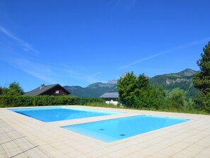 A swimming pool with a mountain backdrop.