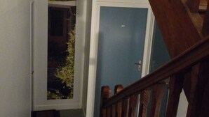 A staircase with wooden railings leading to a door.