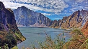 A mountainous landscape with a lake and rugged cliffs. - Bognot Lodge Mt Pinatubo Guesthouse (Capas)