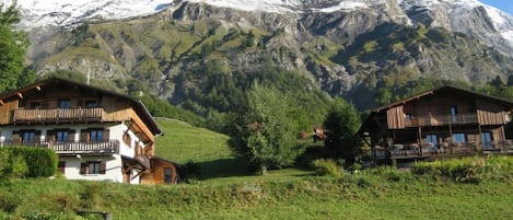 A mountain view with chalet-style buildings in the foreground.