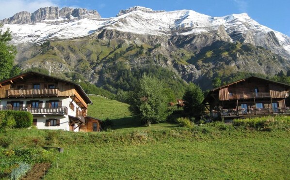 A mountain view with chalet-style buildings in the foreground.