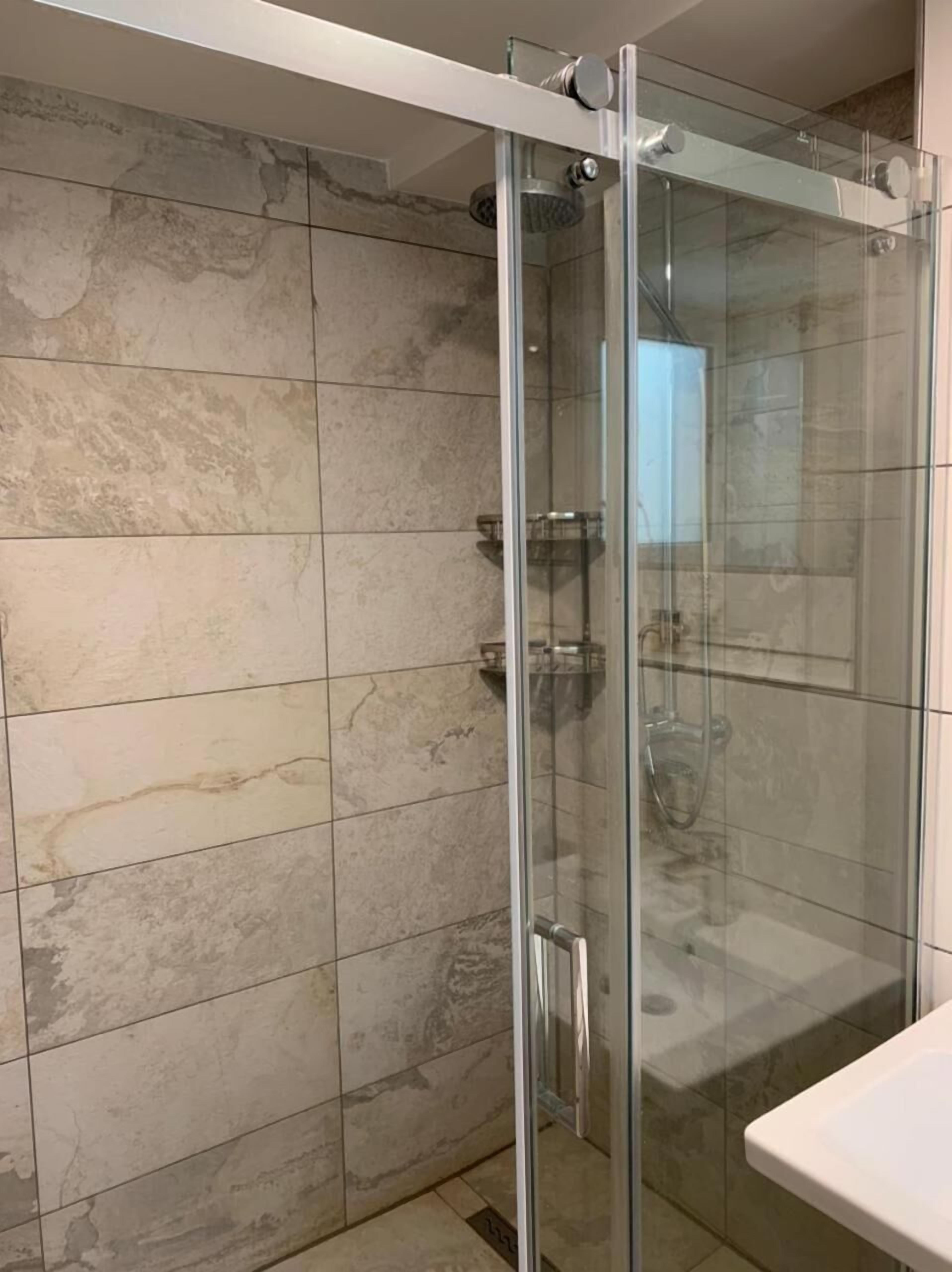 shower, rainfall showerhead, hair dryer, towels