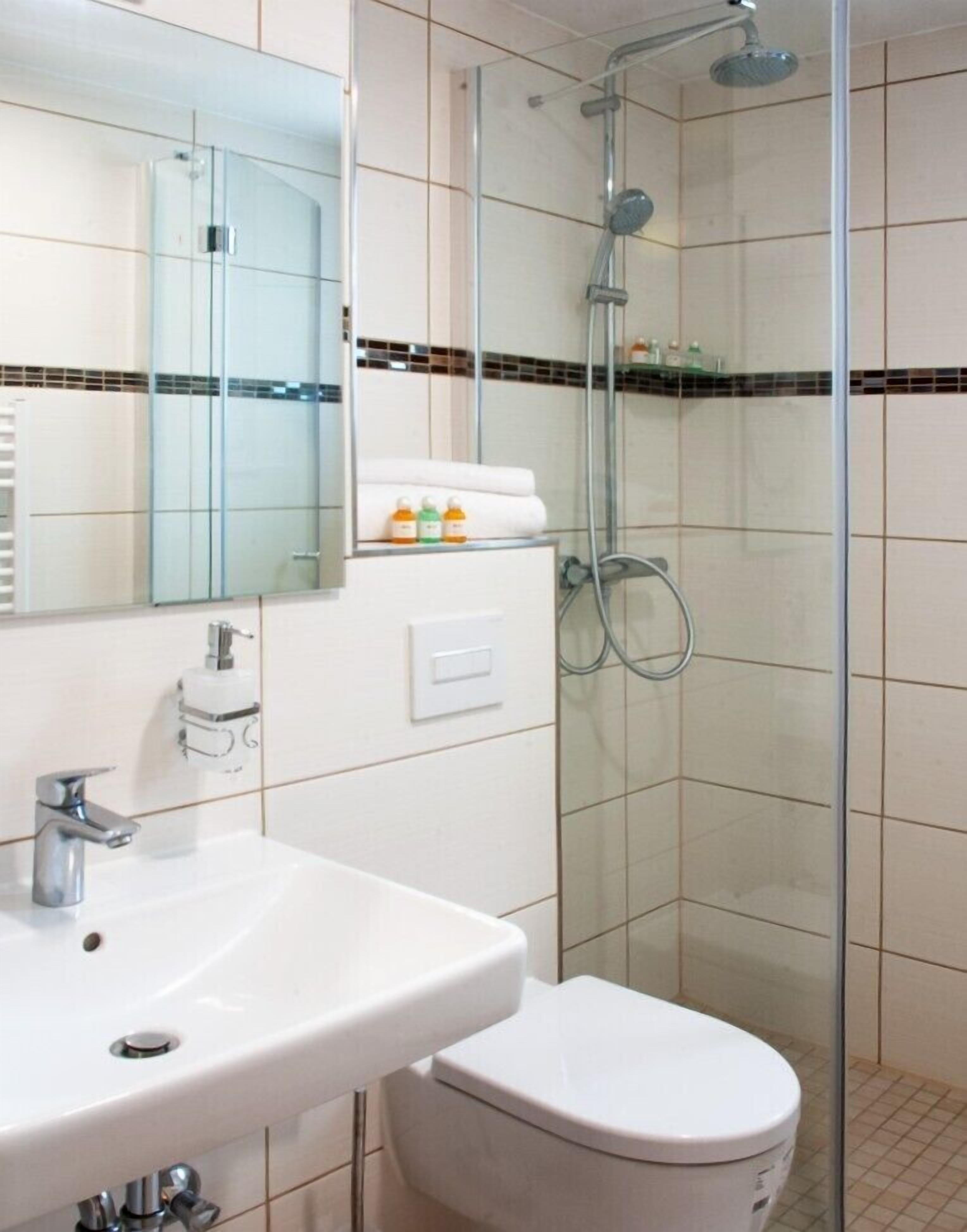 shower, rainfall showerhead, hair dryer, towels