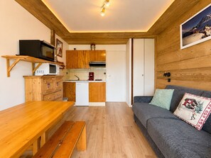 A compact kitchen with wooden cabinets, a microwave, and a coffee maker. - Quiet studio with garden and terrace in Notre-Dame-de-Bellecombe (Notre-Dame-de-Bellecombe)