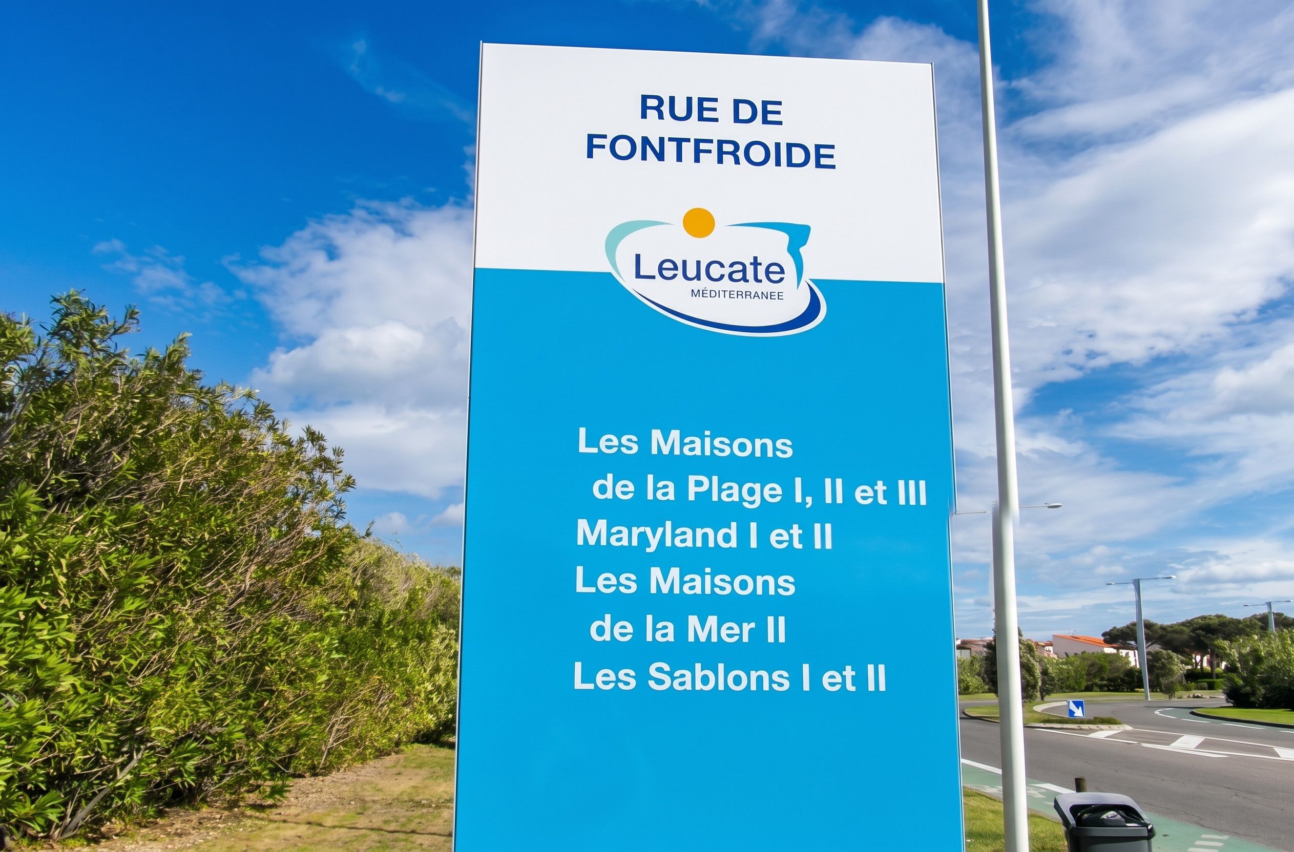 A sign for Rue de Fontfroide with Leucate Mediterranean hotel names listed.