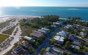 A coastal residential area with houses, a beach, and a clear view of the ocean. - Villa Marisol: Beachfront, Mediterranean style, w/terrace, pool, hot tub! (Anna Maria)