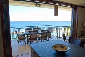 Enjoy a meal at the dining table with ocean views from the large window.