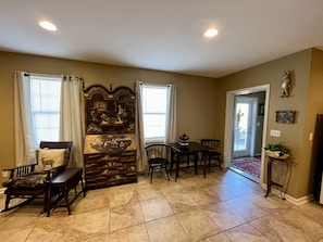 Cozy living room with a fireplace, dining area, and seating space.