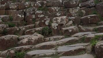 A large, ancient stone structure with irregularly shaped stones stacked in a haphazard manner.