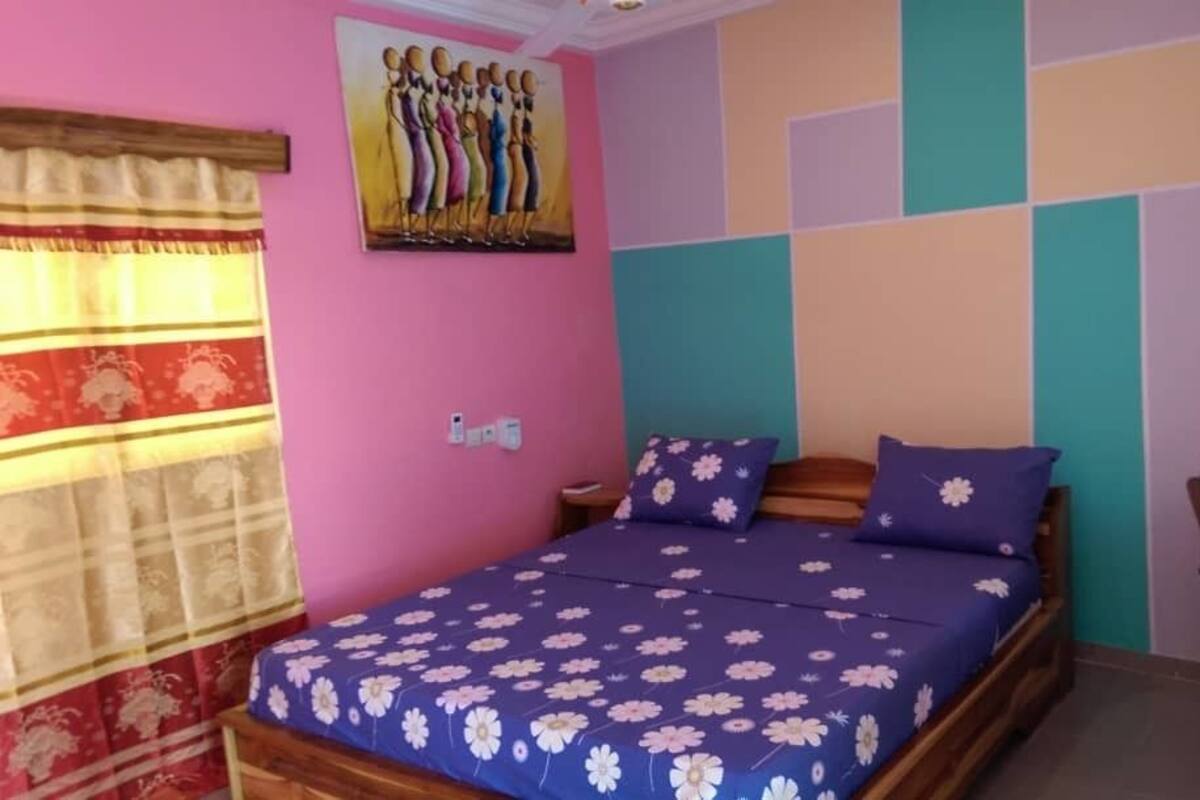 Ein Schlafzimmer mit einem Bett, einem Nachttisch, einem Tisch und einem Stuhl.