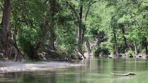 A calm river surrounded by dense trees. - Guadalupe River, Hill Country Texas (Boerne)