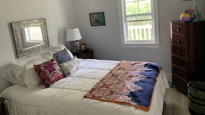 A bedroom with a bed, a dresser, a TV, a window, and a ceiling fan. - The Palms...A beautiful space in the perfect place. (Key West)