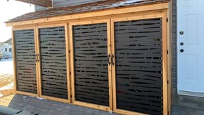 A wooden garage with frosted glass doors and a white door to the right. - Dragonfly Inn, Loft Suite with private entrance. (Sherwood Park)