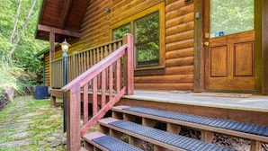A wooden cabin with a porch, steps, and a door with a window. - Appalachian Adventure - 4 Bedroom sleeps 14! (Gatlinburg)