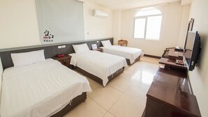 A hotel room with two beds, a desk, a TV, and a large window. - Taijing Hotel (Beigan)