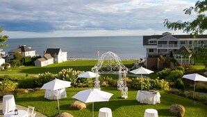 A coastal resort with outdoor seating, a gazebo, and a view of the sea.