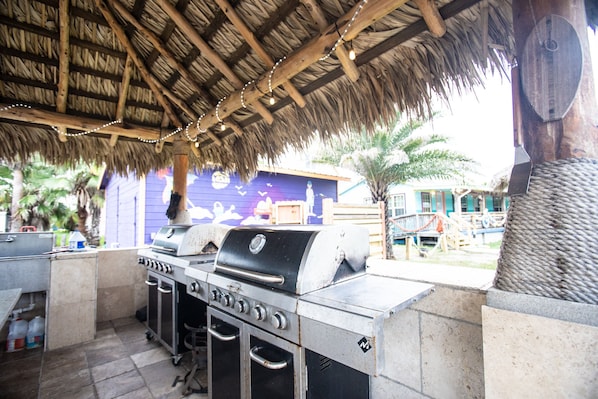Enjoy cooking for large gatherings in this outdoor kitchen with a gas range and oven.