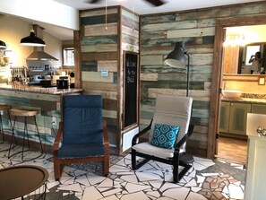 Relax in this inviting space with a bar, seating area, and kitchenette.