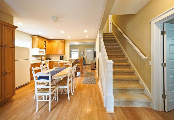 Enjoy a family-friendly kitchen and dining area with a spacious layout and a staircase leading to an upper level.