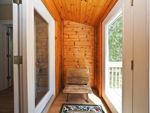Cozy retreat with a bench for seating and a sliding door to a connected space.