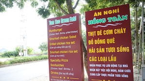Two signs advertising food and drink options at Tom COC Green Field. - TamCoc Green field Hostel (Nam Hoa Lu)