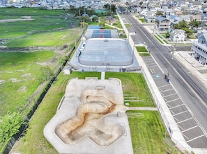 An aerial view of a sports complex with a basketball court, a parking lot, and surrounding residential buildings. - WildWoof Beach Bungalow @ North Wildwood - No Pet Fees! (North Wildwood)