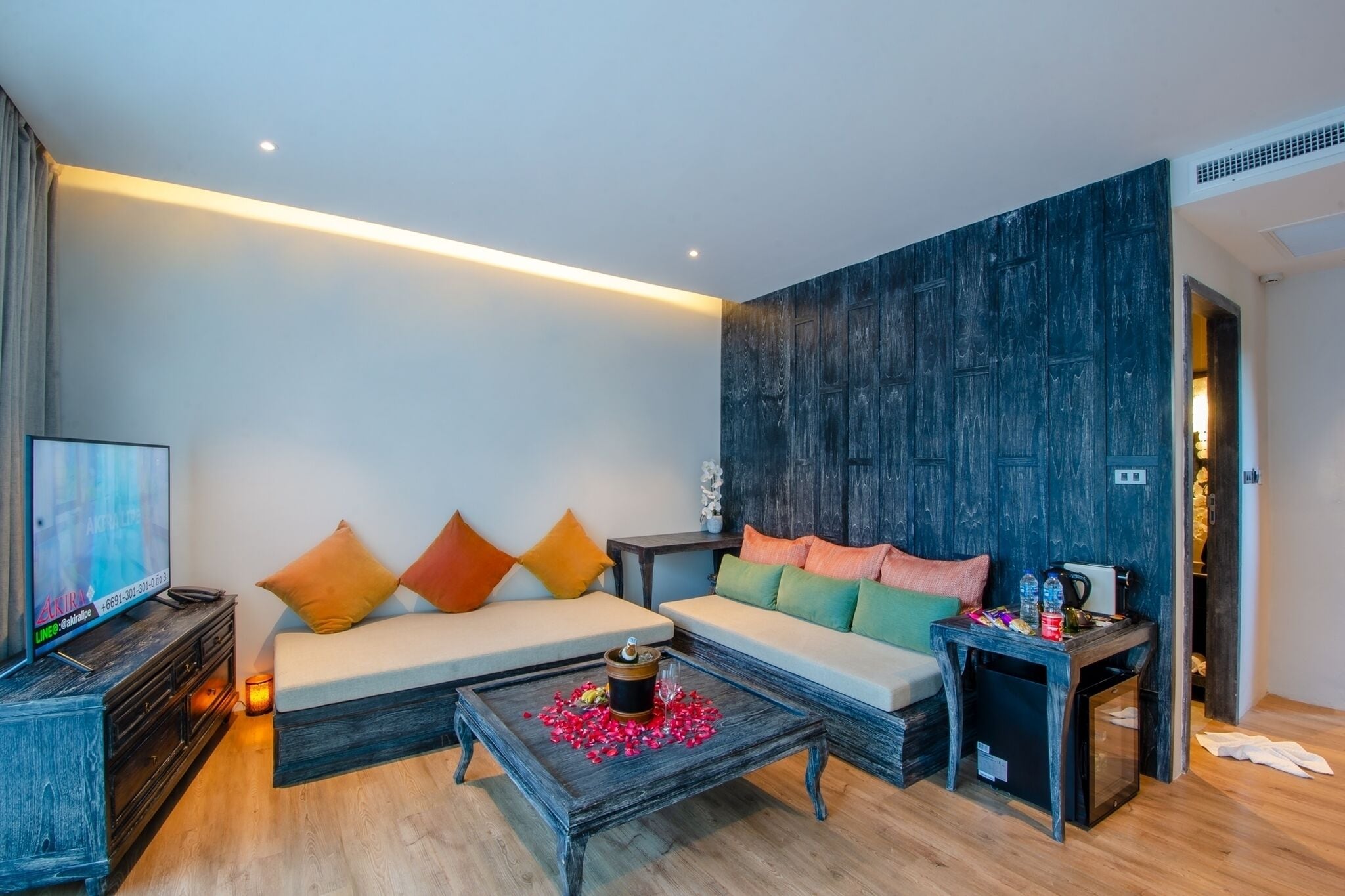 A modern living room with a sofa, coffee table, and a television.