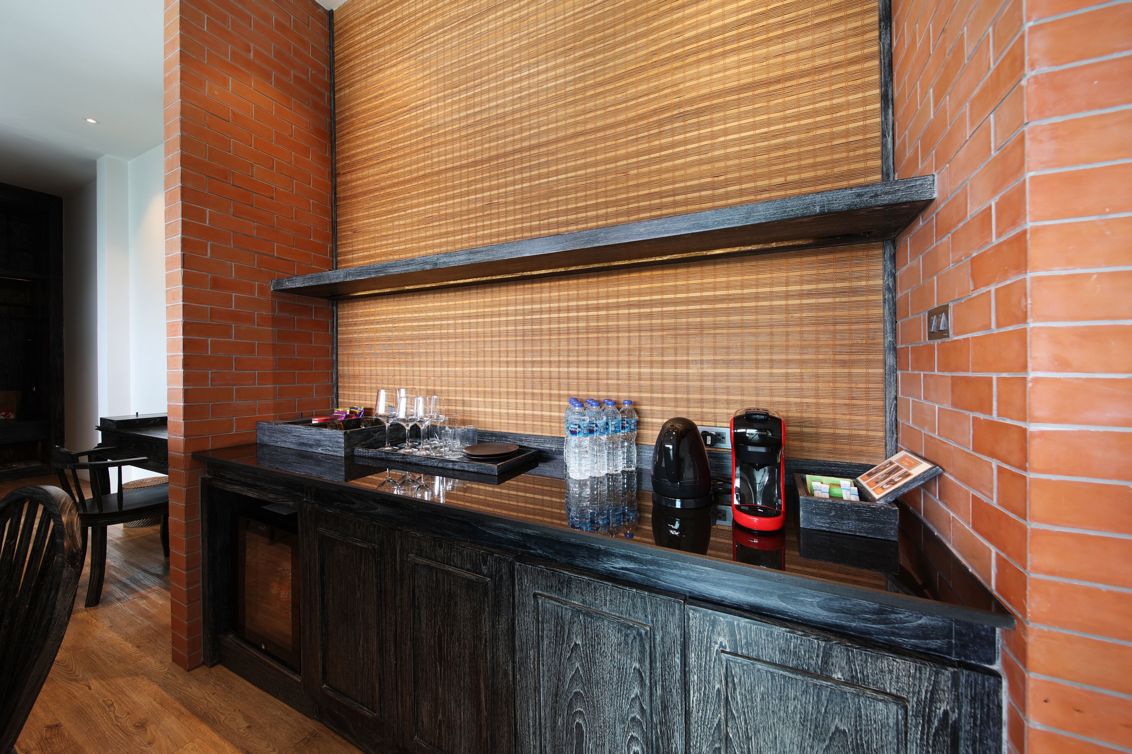 A reception area with a wooden counter, a coffee machine, and a water dispenser.