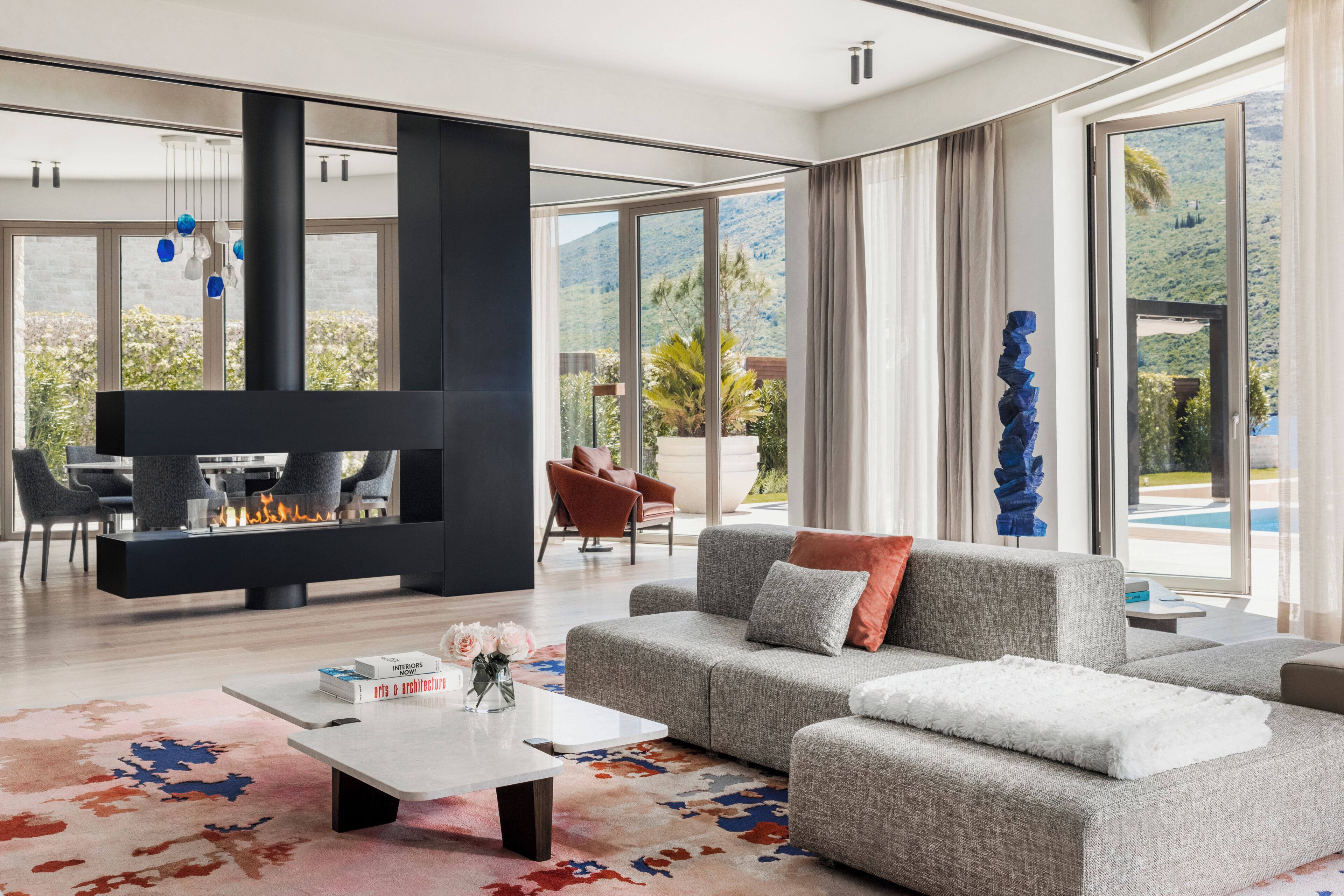 A modern living room with a fireplace, a sofa, and a coffee table.