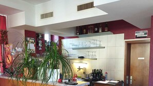 A modern kitchen with a wooden island, a built-in stove, and a tiled backsplash. - Hotel Edelweiss (Neuhausen am Rheinfall)